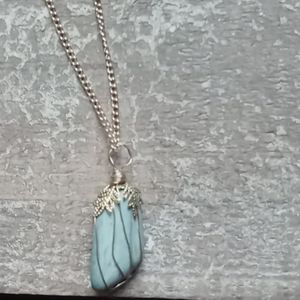 Piece of jade enveloped with wires of gold.